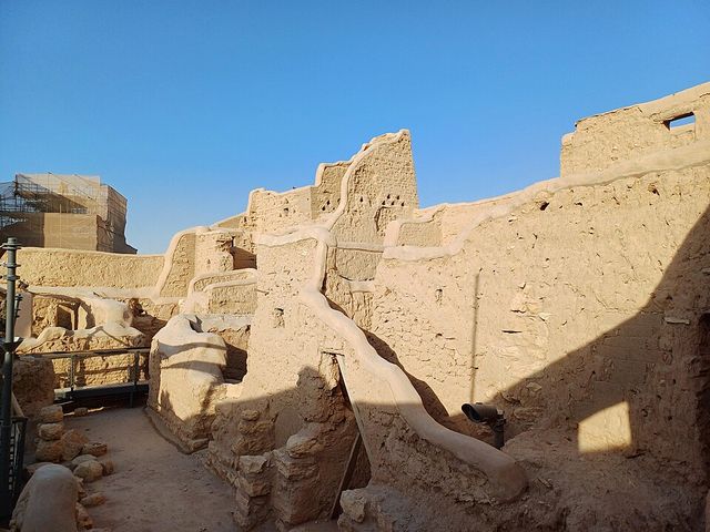 Mud-brick walls of At-Turaif in ad-Dir&rsquo;iyah under a clear blue sky